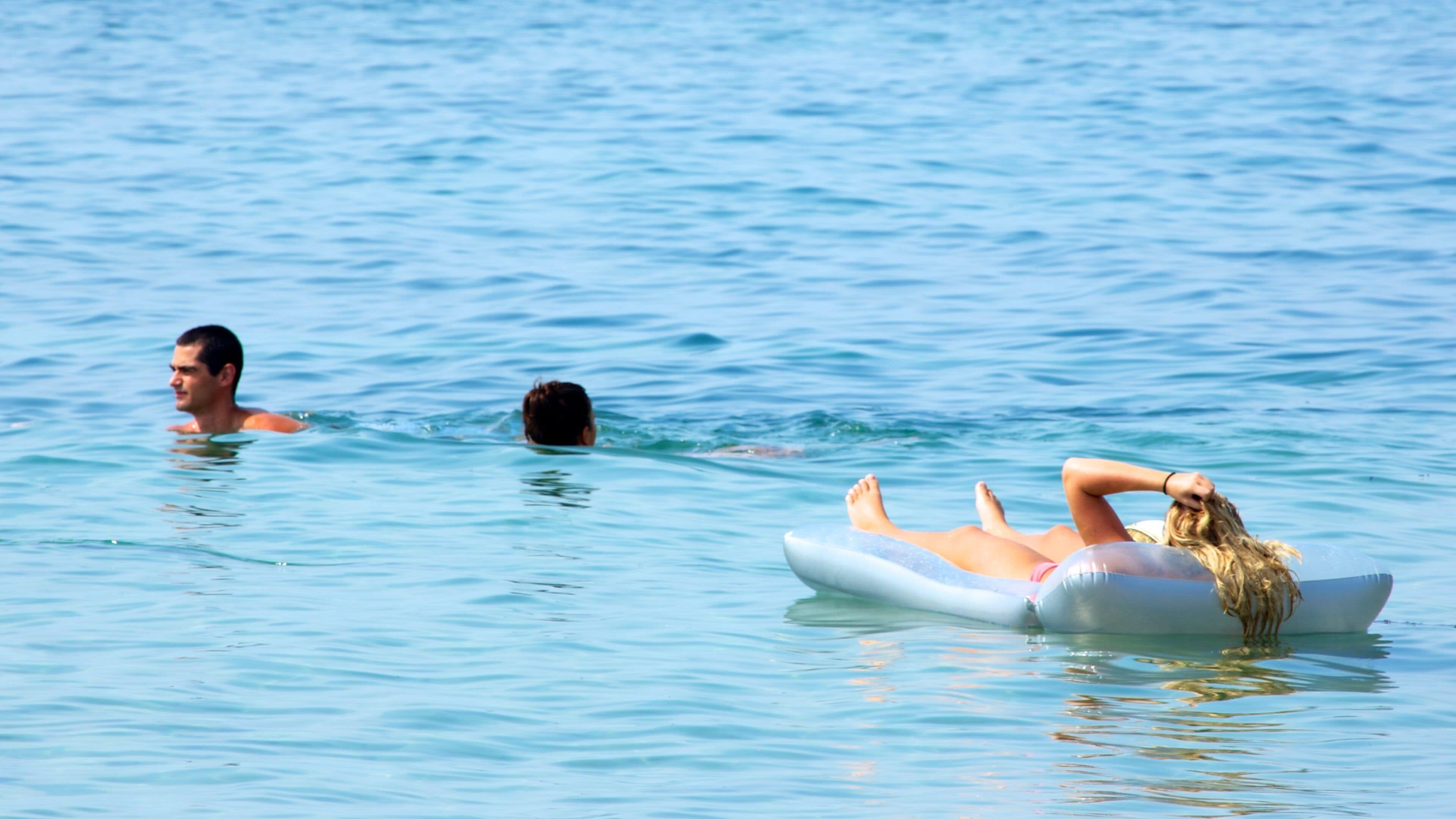 Segara Beach which includes swimming and surf as well as a small group of people