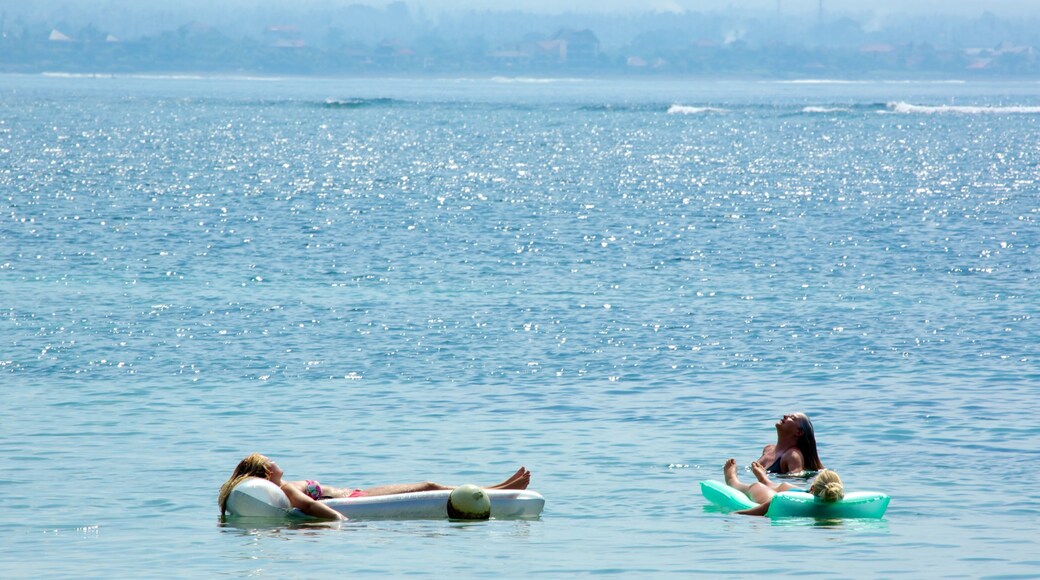 Segara Beach showing surf and swimming as well as a small group of people