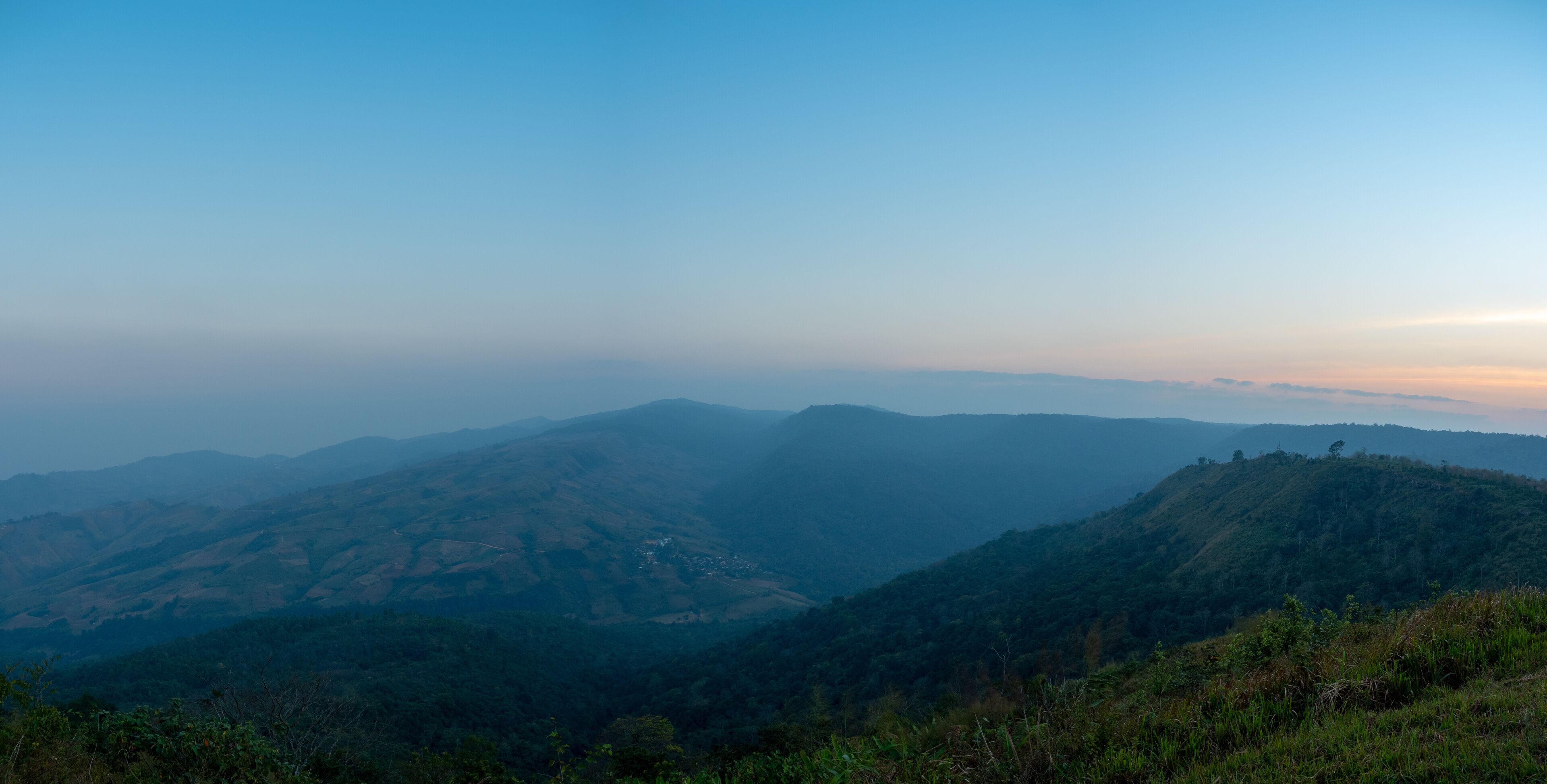 Phu Lom Lo mountains and valley, panoramic view, evening light with fog.