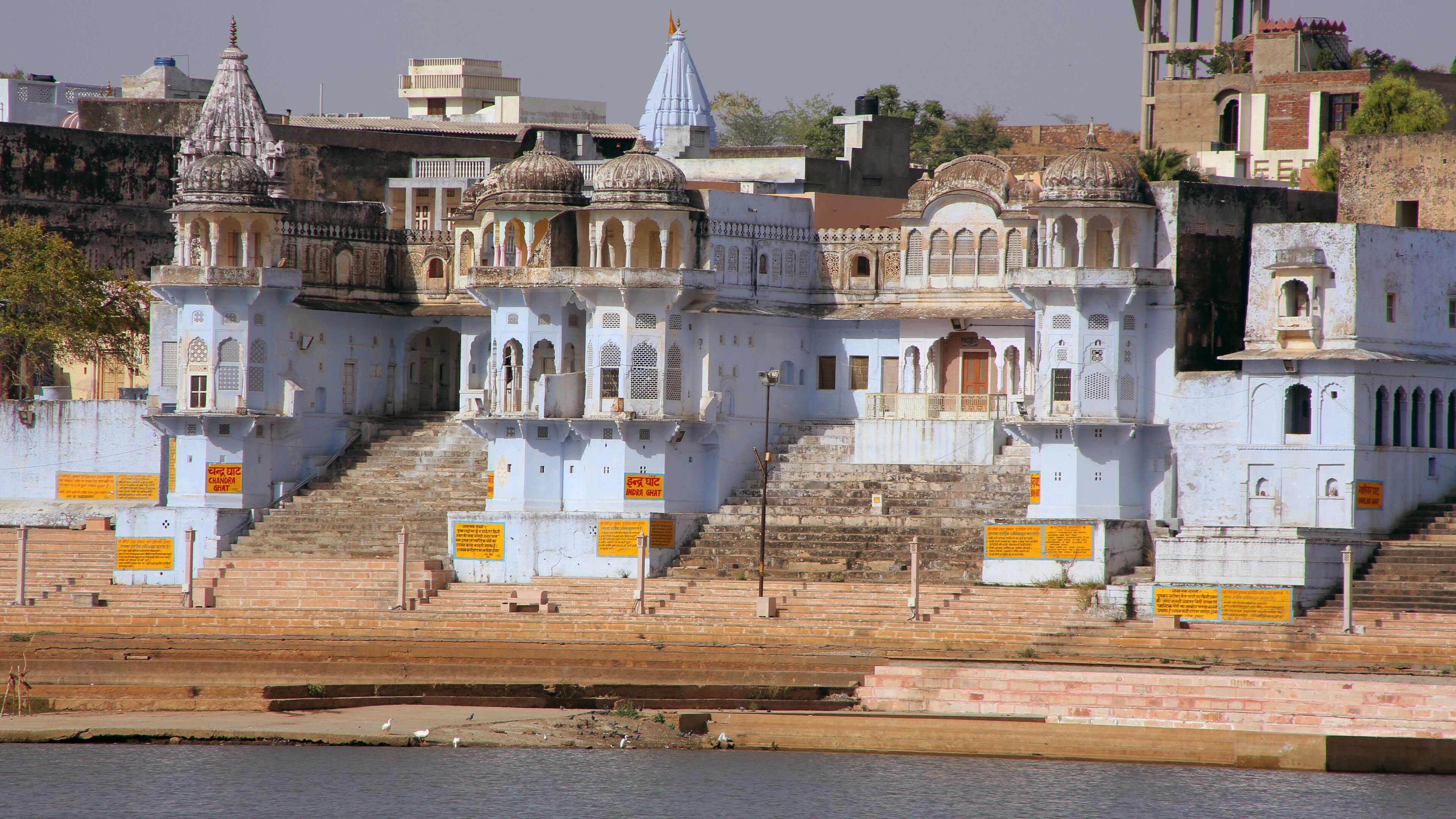 A temple complex with multiple domes and steps leading up to it.