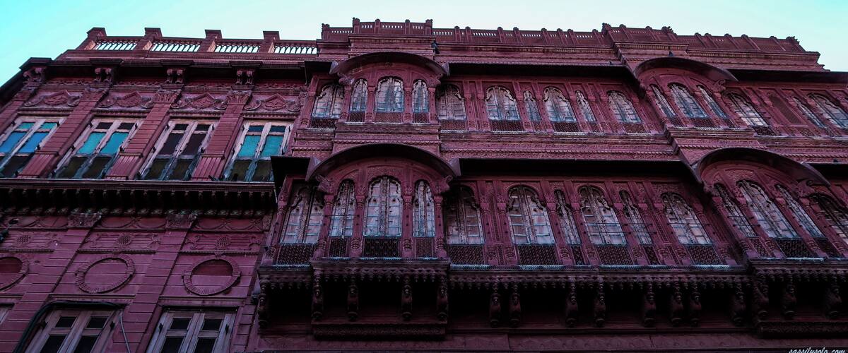 A large, ornate building with intricate architectural details and multiple arched windows.