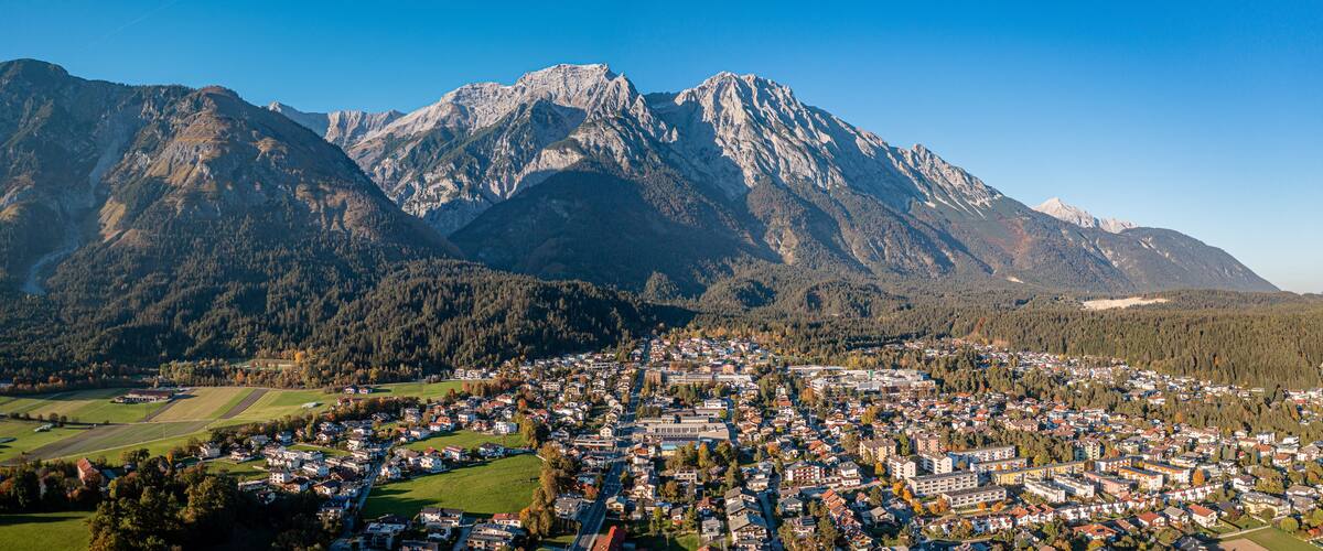 A town nestled between mountains with a clear sky.