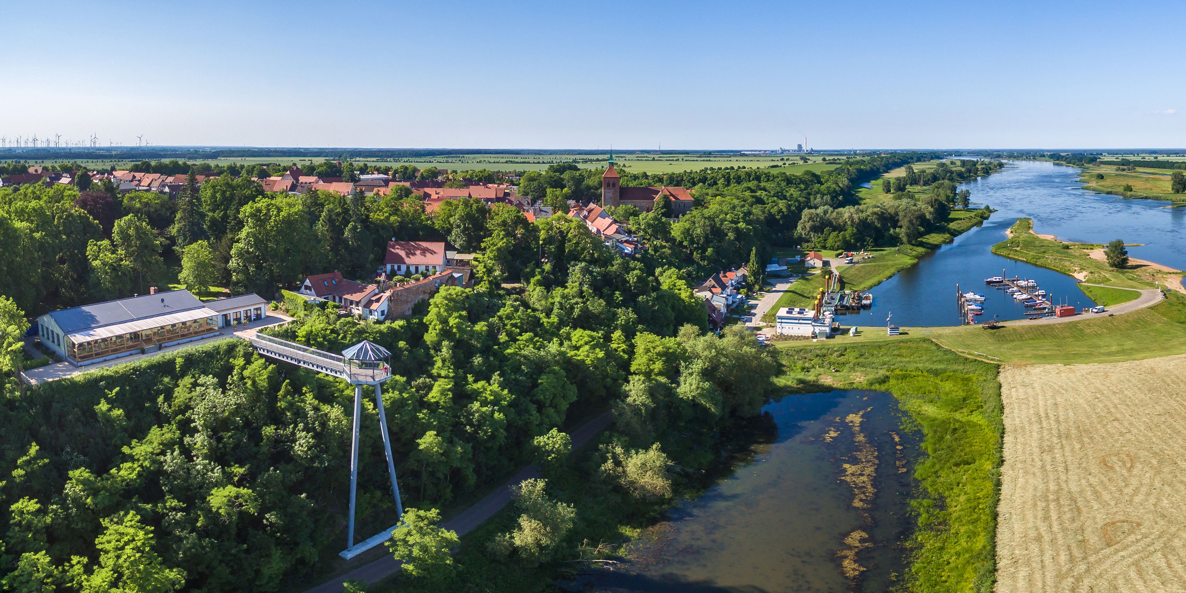 A river with boats, a bridge, and a tower.