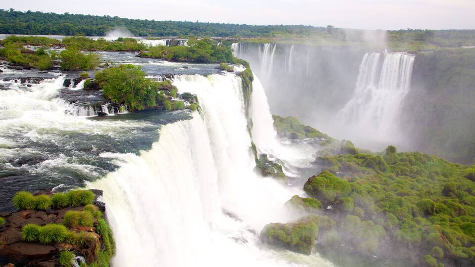 A large waterfall with multiple cascades surrounded by lush greenery.