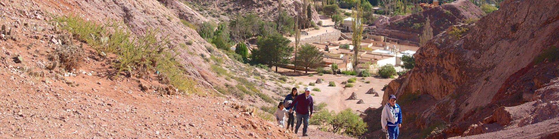 A rugged mountainous landscape with a small settlement nestled in the valley.