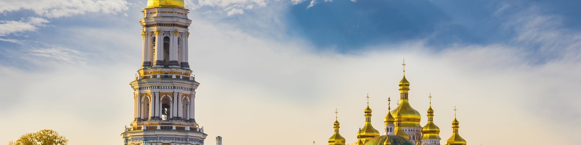 Kiev-Pechersk Lavra against the sky with clouds autumn. Big Bell tower, Refectory Church and Assumption Cathedral. Kiev, Ukraine