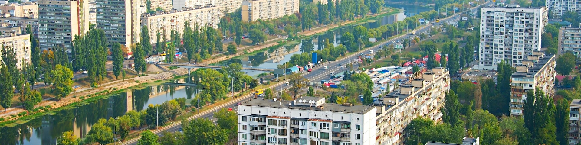 A cityscape with high-rise buildings, a river, and a bridge.