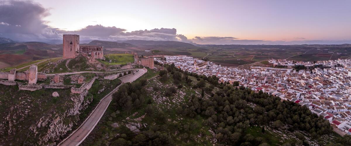 A historic castle on a hill overlooking a village.