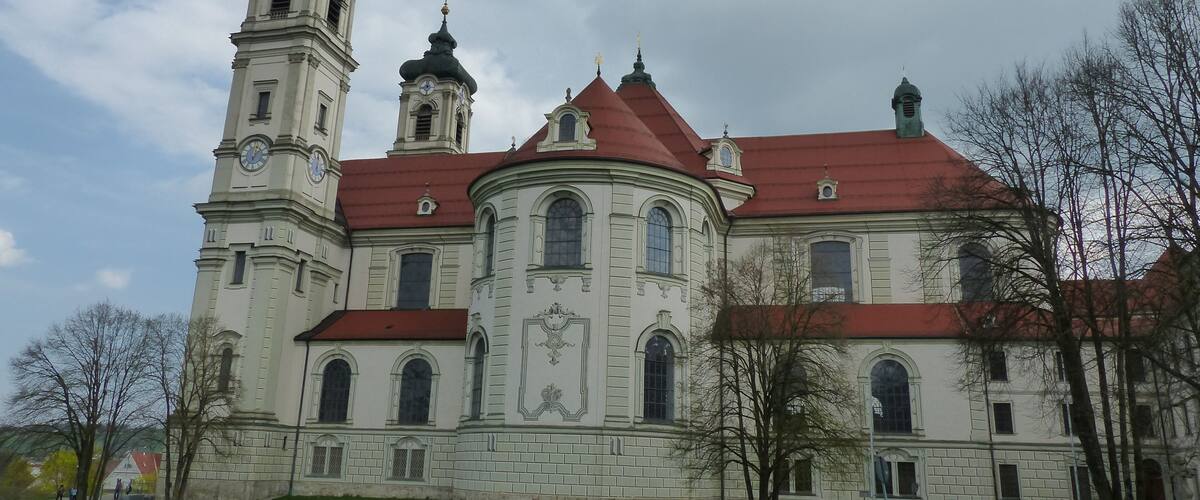 A historic church with a clock tower and red roof.