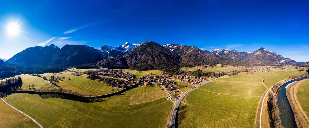 A mountainous landscape with a village nestled in the valley.