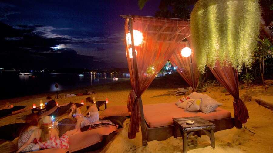 Fishermans Village showing night scenes and general coastal views as well as a small group of people