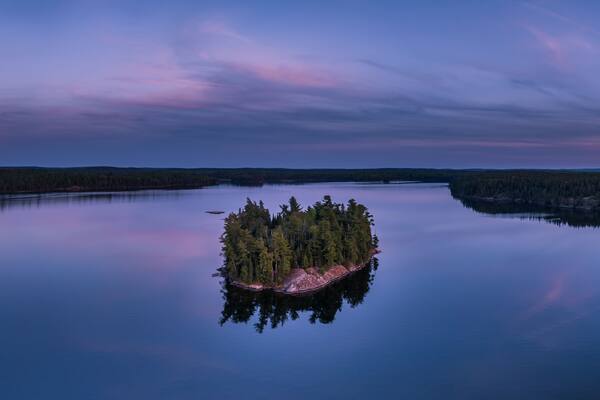 A lonely little island on Eagle Lake at blue hour in Northwest Ontario, Canada.