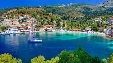 A coastal town with colorful houses, clear turquoise waters, and boats.