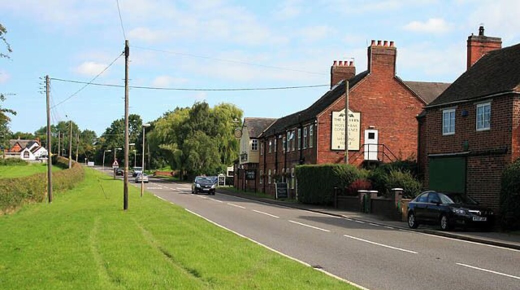 Entering Sibson from the South The road is the A444. Both Sibson pubs are visible here, The Millers in the centre of the picture, the Cock Inn is the white building on the far left.