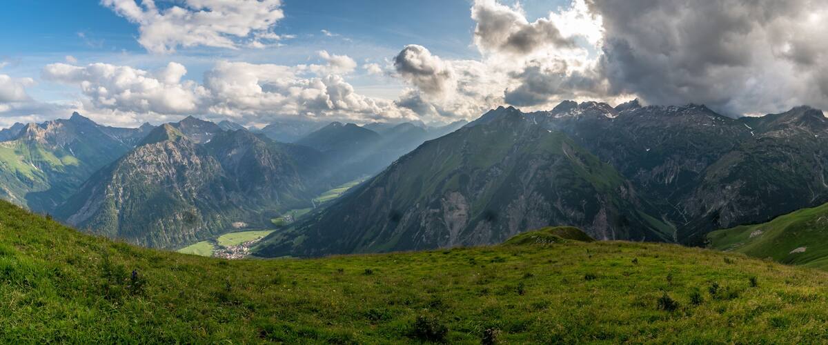A mountainous landscape with a valley and a small town.