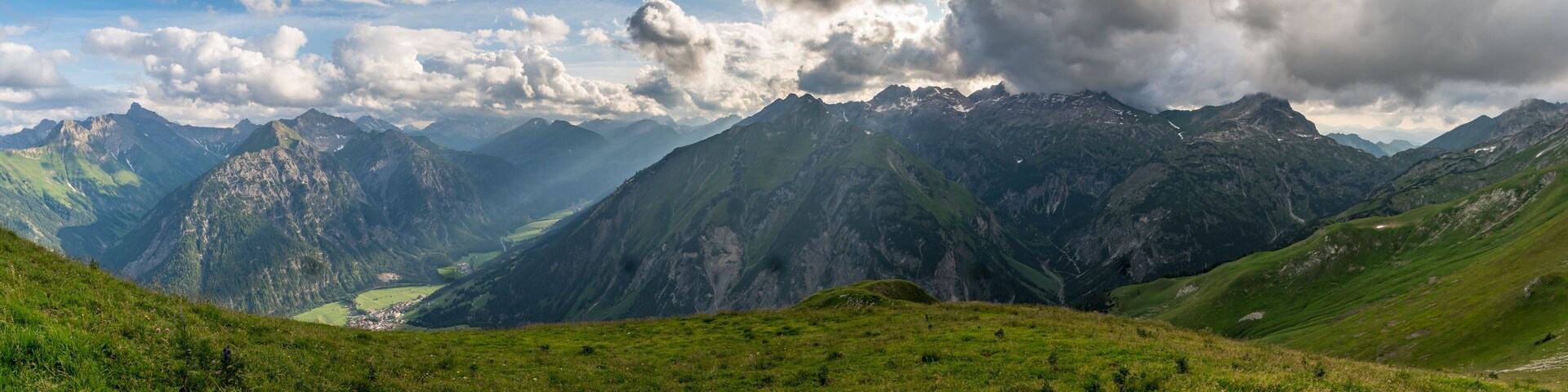 A mountainous landscape with a valley and a small town.