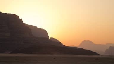 Wadi Rum which includes a sunset, desert views and a gorge or canyon