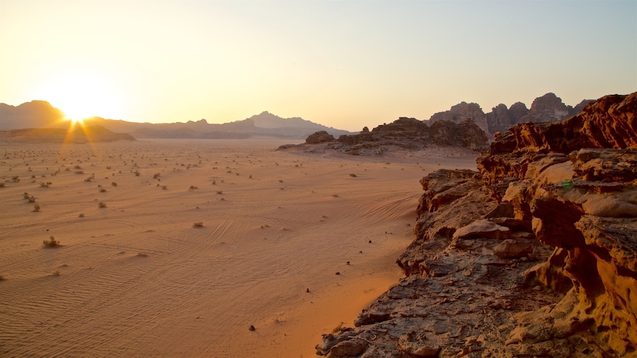 Wadi Rum featuring landscape views, a gorge or canyon and a sunset