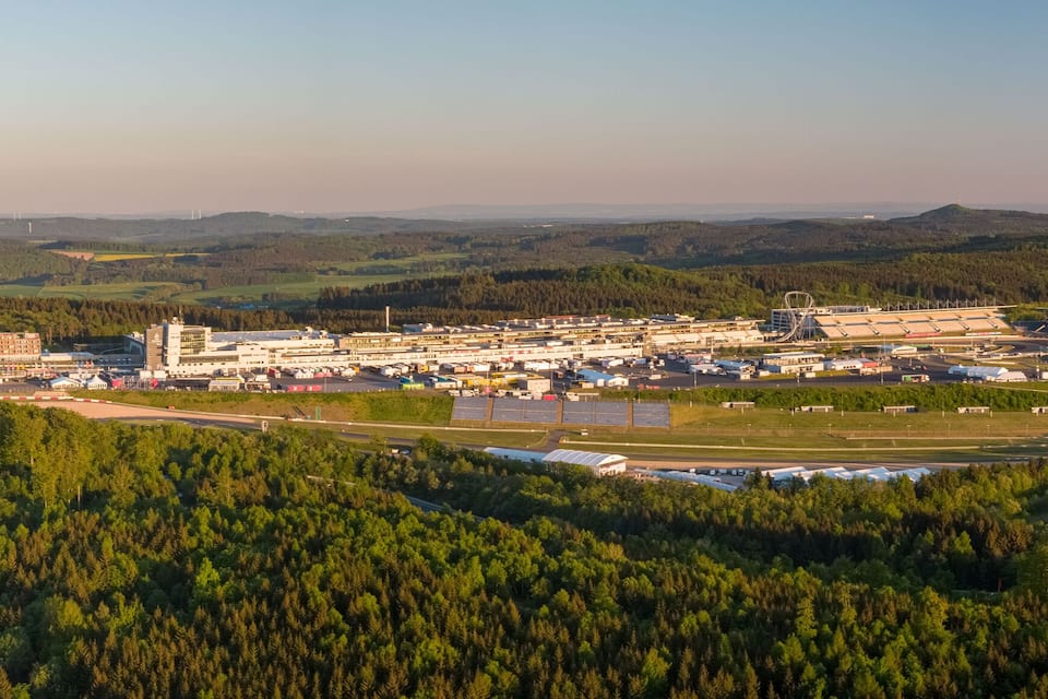 A large industrial complex with multiple buildings and a winding road.