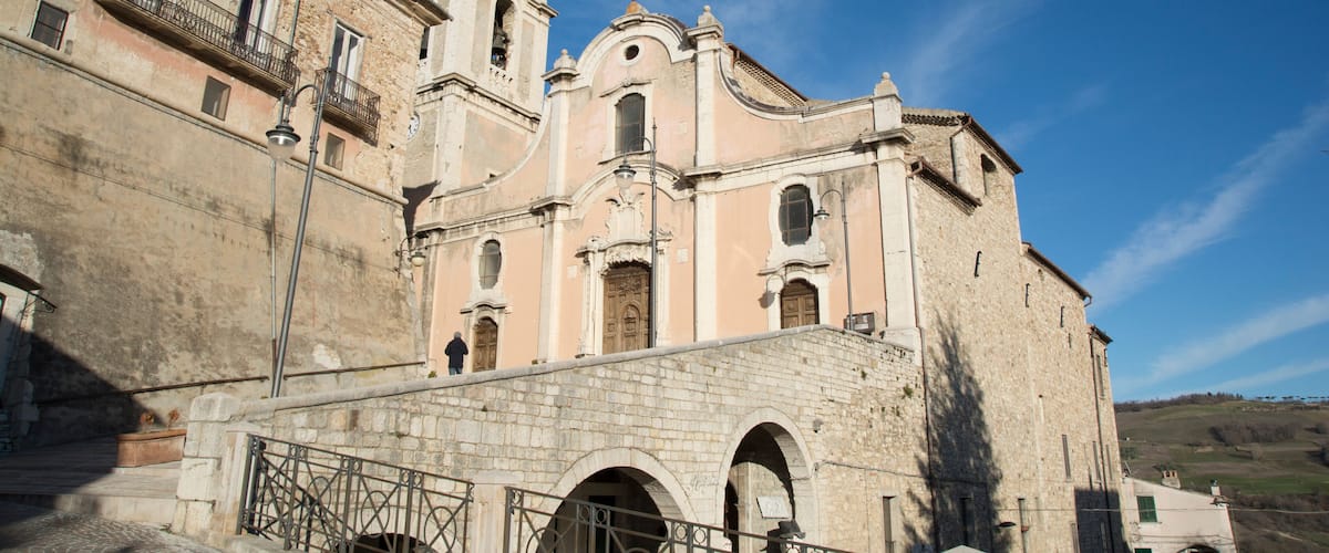 A historic church with a bell tower and arched windows.