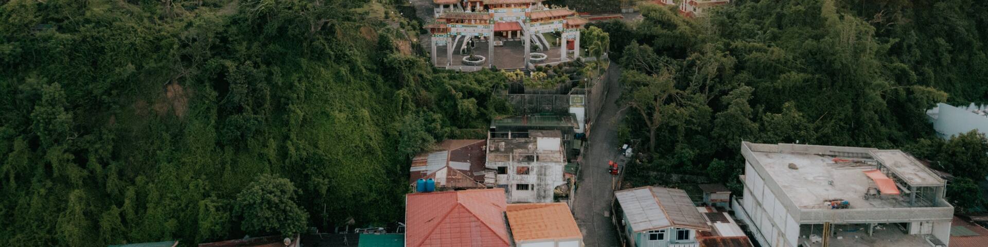 Aerial View of Ma-Cho Temple Surrounded by Lush Trees in San Fernando, La Union, Philippines at Sunrise