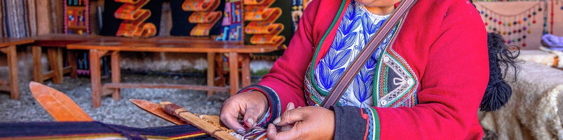 A person weaving colorful textiles.
