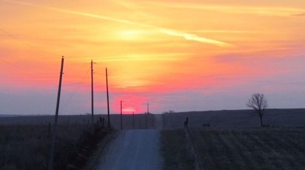 Sunrise over prairie and farmland