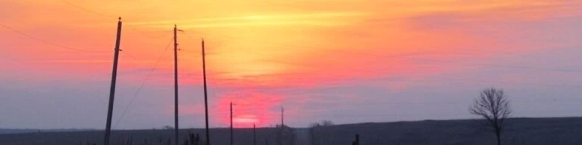 Sunrise over prairie and farmland