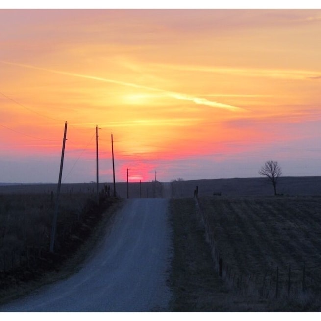 Sunrise over prairie and farmland