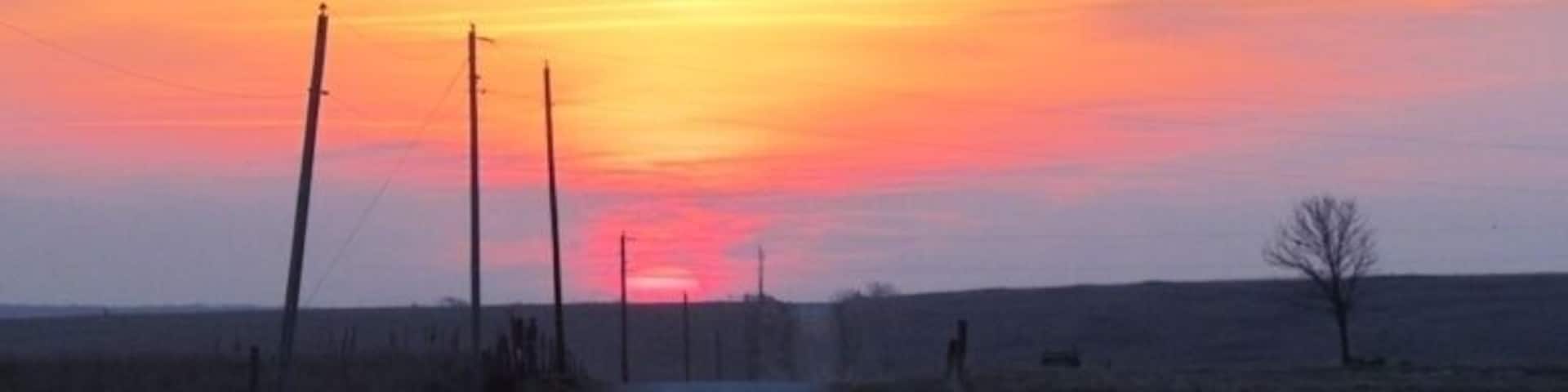 Sunrise over prairie and farmland