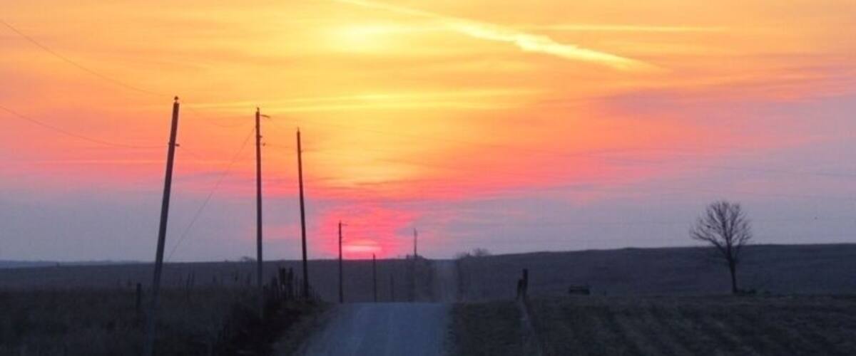 Sunrise over prairie and farmland
