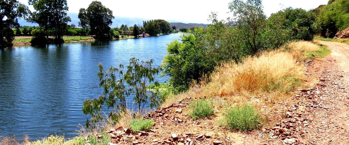 A river with a rocky path alongside.