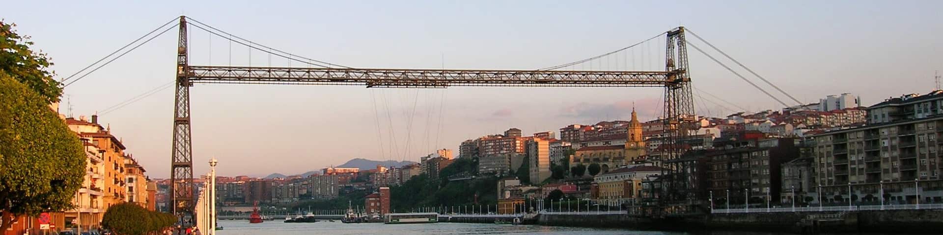 Bizkaia Zubia (Biscay Bridge) Transporter Bridge between Portugalete a Las Arenas - Areeta. The upper horizontal span is a footbridge that can be accessed through lifts (elevators).