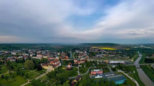 180 degerees panoramic cityscape about Szentgotthard town in west Hungary. The Cistercian abbey' church and garden in visible in the middle.