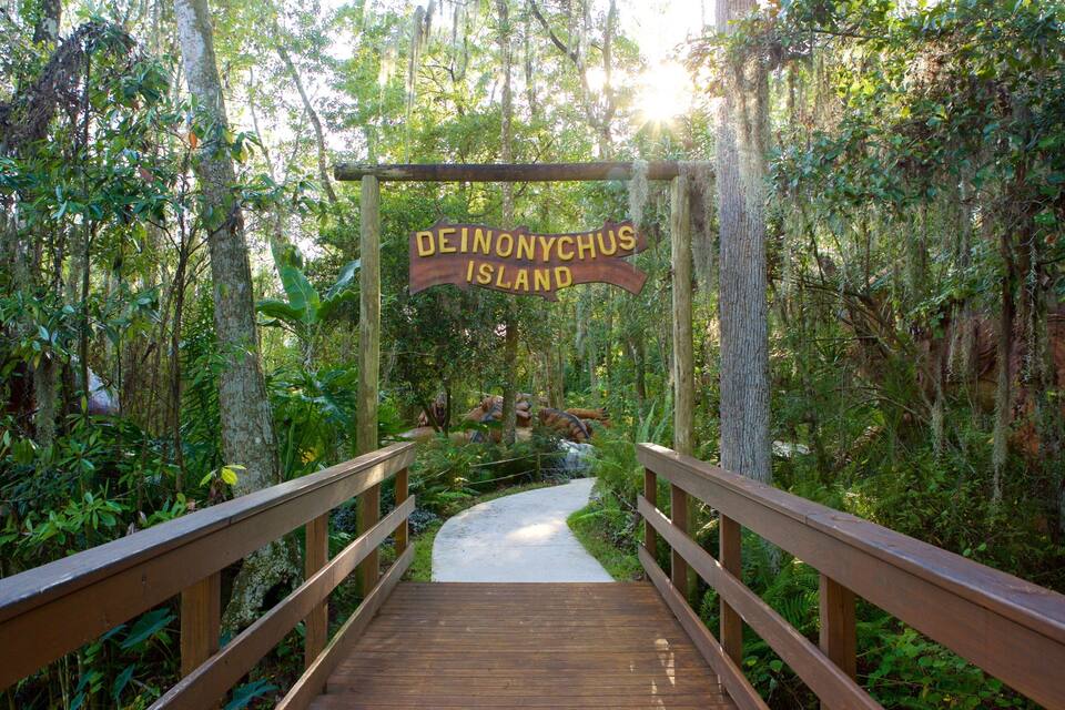 A wooden boardwalk leading to a sign that reads "Deinonychus Island."