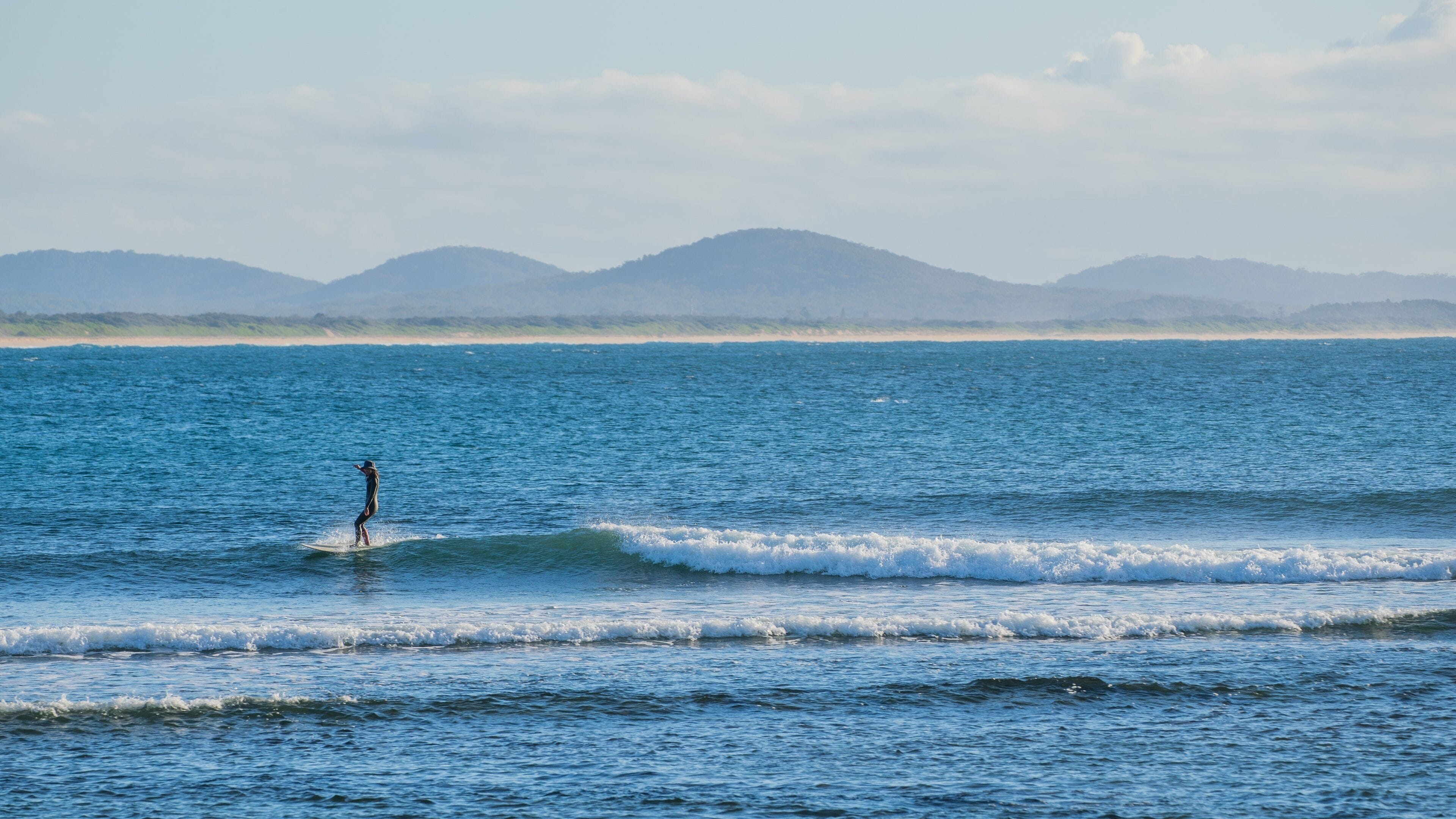 Woolgoolga featuring general coastal views, surfing and waves