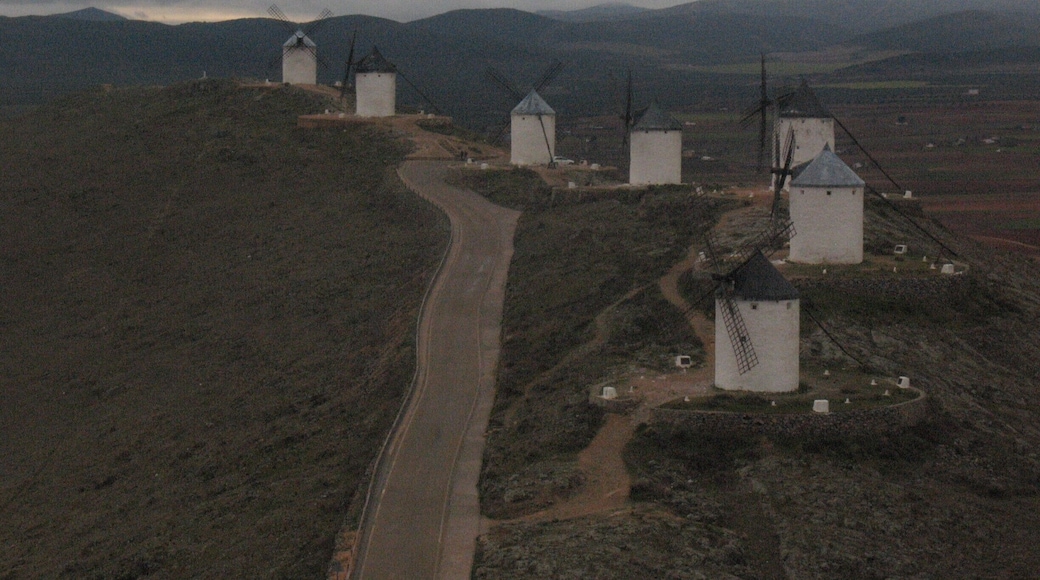 I believe these windmills were constructed after Don Quixote was published, inspired by the windmills that inspired Cervantes. There's also a castle along this route that you can explore.
You can reach Consuegra and Molino Rucio via a bus from Toledo (at least you could in 2011)