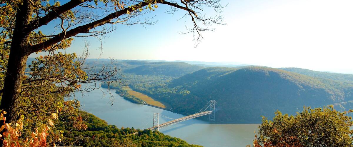 A river, a bridge, and surrounding hills.