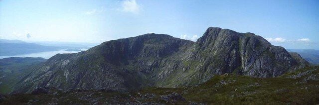 A rugged mountain range with a lake in the background.