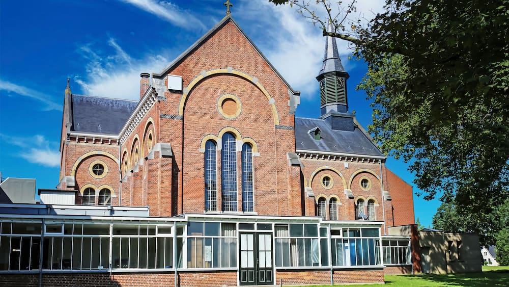 Venray (Vincent van Gogh mental hospital), Netherlands - July 9. 2023: Beautiful park with church in dutch mental psychiatric clinic