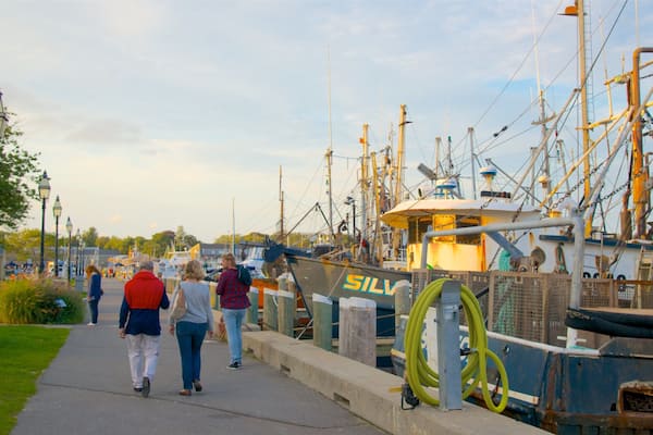 Hyannis Harbor which includes a bay or harbour and a sunset as well as a small group of people