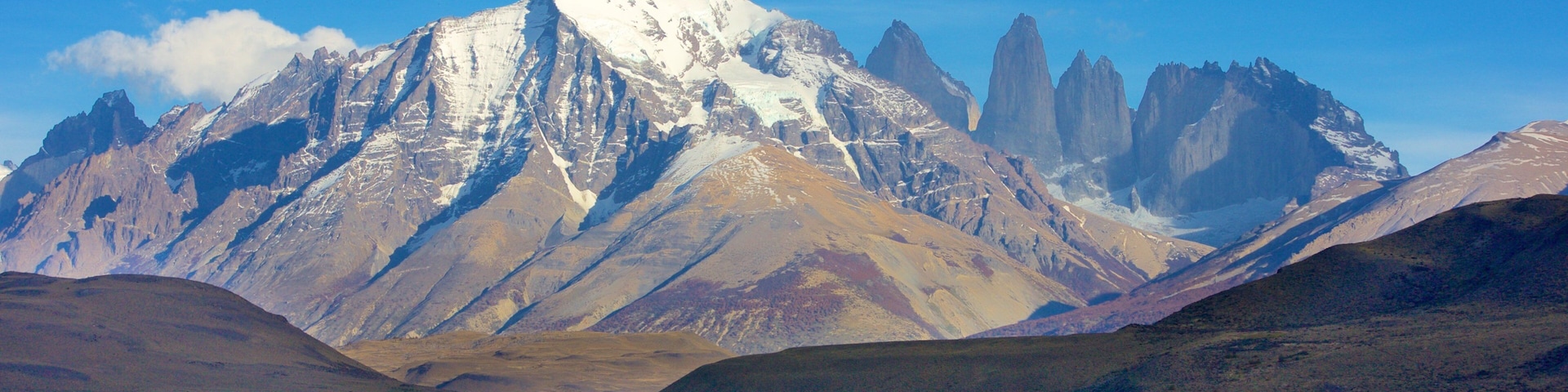 A mountain range with a lake in the foreground.
