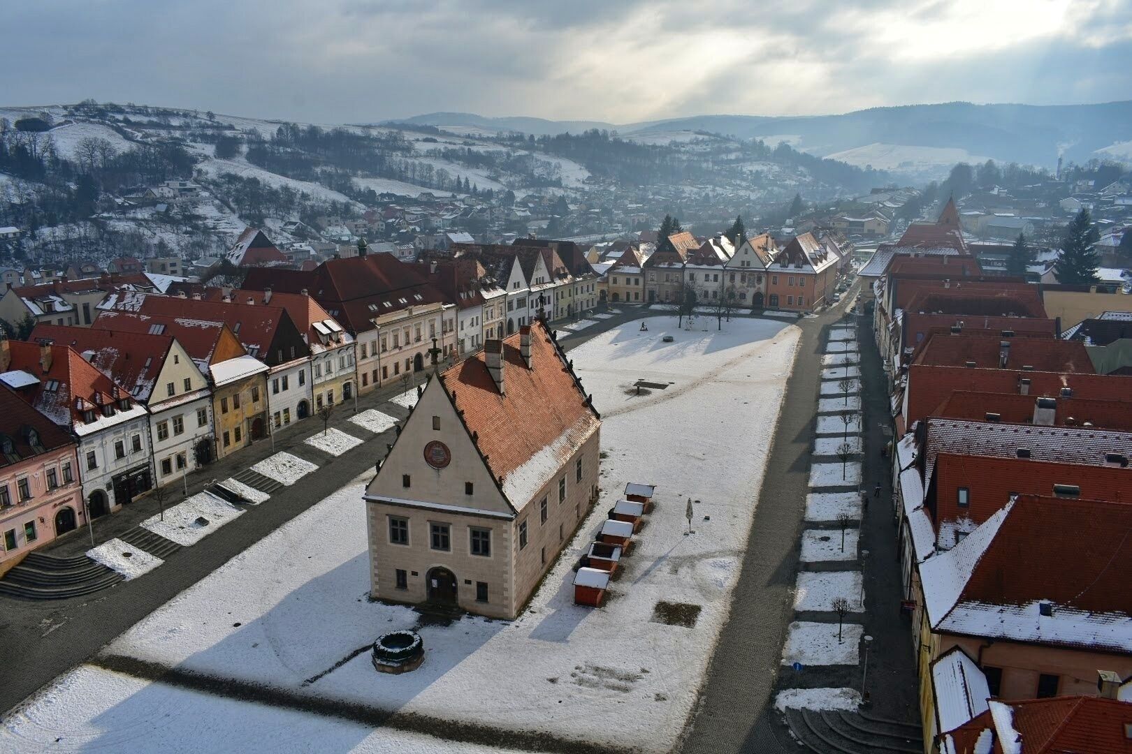 A snow-covered town with historic buildings and a central square.
