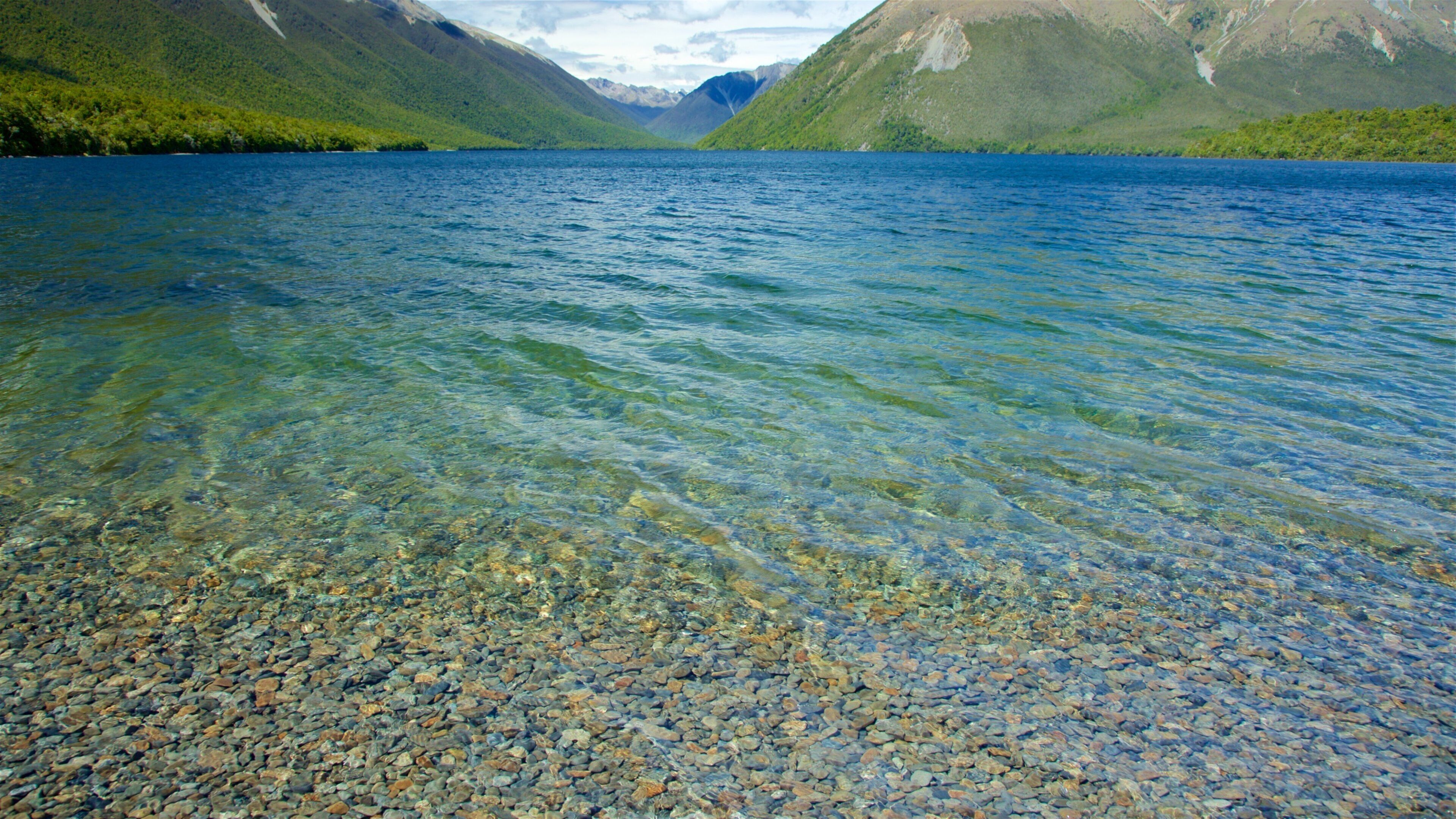 Nelson Lakes National Park showing mountains, a bay or harbor and a pebble beach