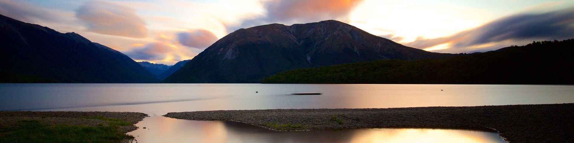 Nelson Lakes National Park featuring a sunset, mountains and a bay or harbor