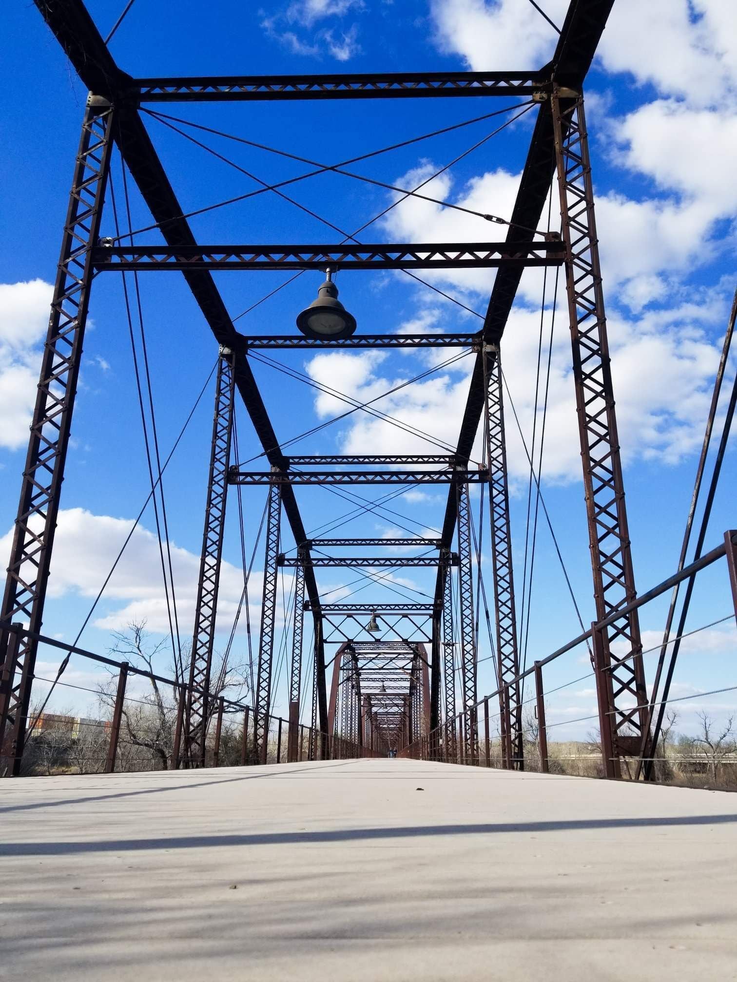 In 1916 a steel bridge was built over the waters of the Canadian River for wagon travel. The 3,255 ft pin-connected bridge is the longest in the state. It was closed in 1953 when a new bridge was constructed. In 2000 it was completely restored and is now the focal point for a scenic hike-and-bike trail. The bridge provides a platform for viewing wildlife, including white-tailed deer, wild turkey and waterfowl.
