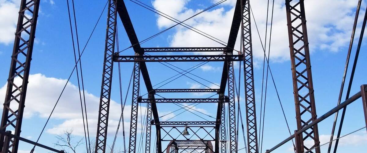 In 1916 a steel bridge was built over the waters of the Canadian River for wagon travel. The 3,255 ft pin-connected bridge is the longest in the state. It was closed in 1953 when a new bridge was constructed. In 2000 it was completely restored and is now the focal point for a scenic hike-and-bike trail. The bridge provides a platform for viewing wildlife, including white-tailed deer, wild turkey and waterfowl.
