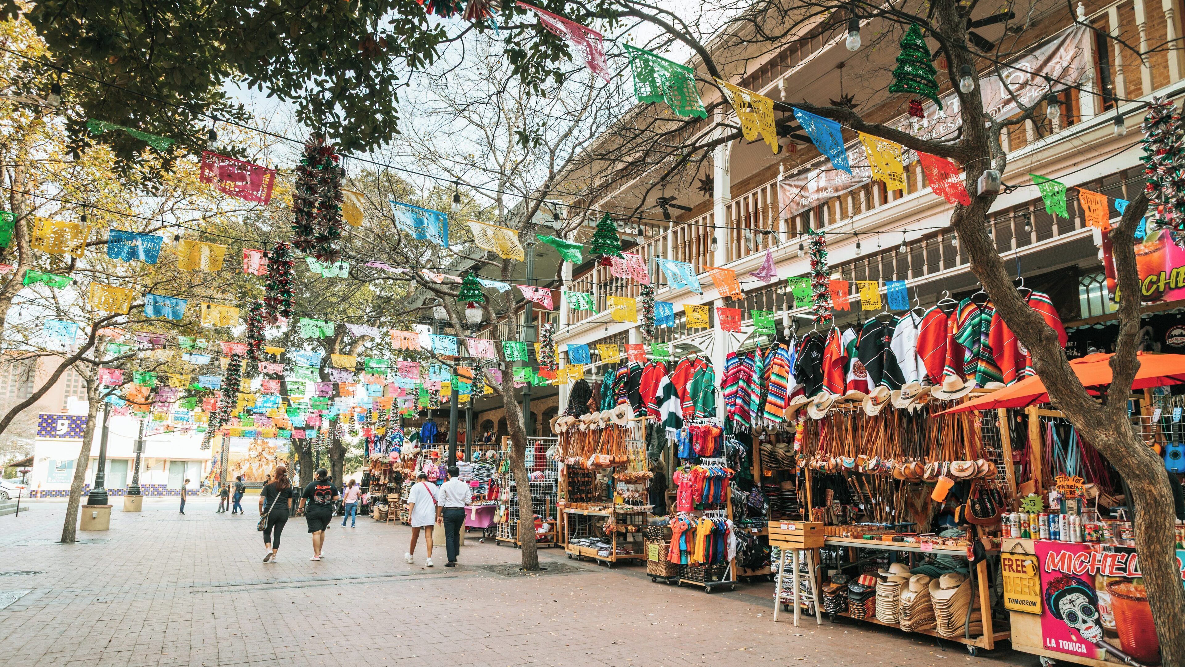 Vibrant market square in downtown San Antonio showcases local culture and festive decorations during a busy day