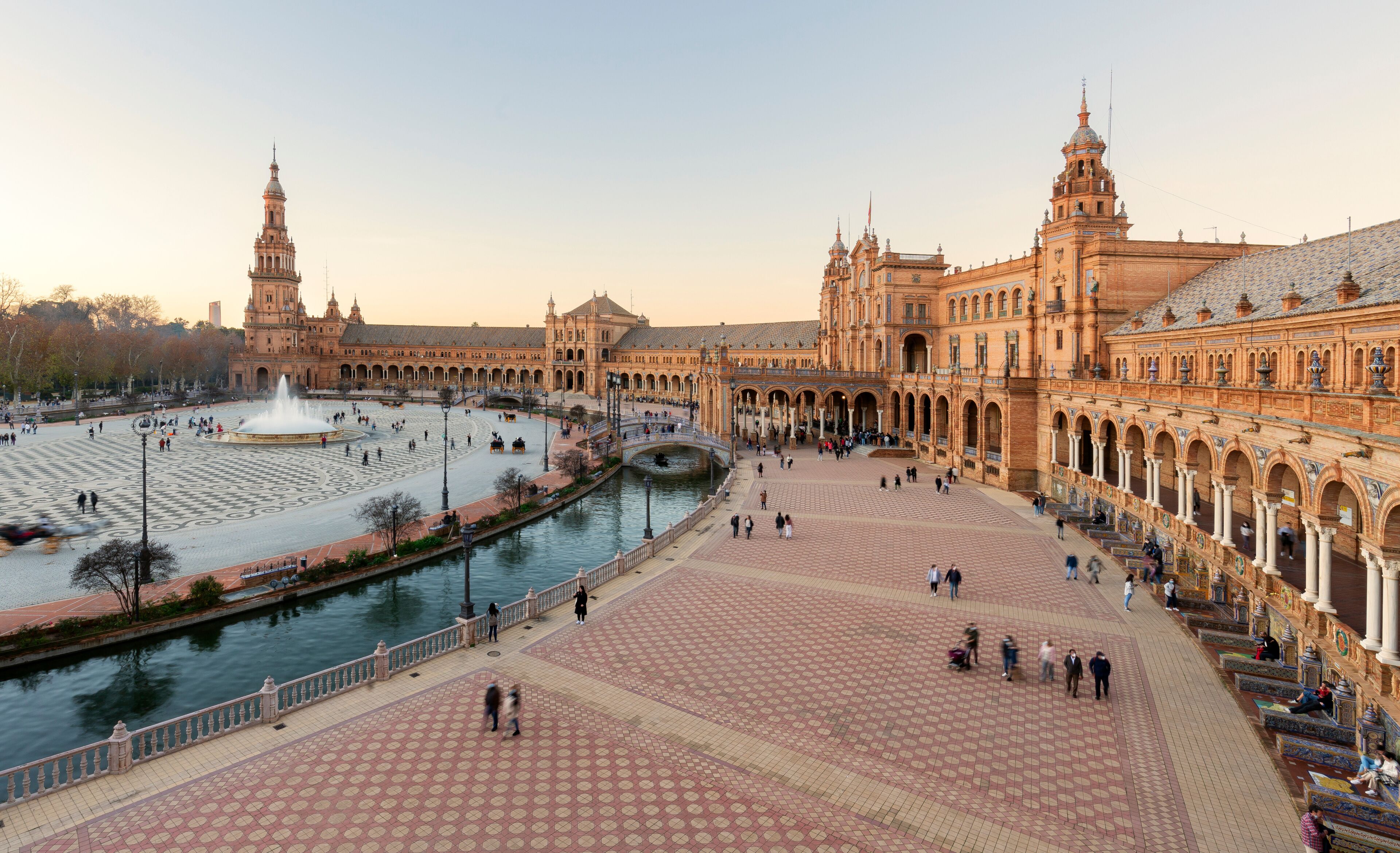 scenic view of Plaza de España The Plaza de España is a plaza in the Parque de María Luisa, Historical landmark in Seville sunset, Spain