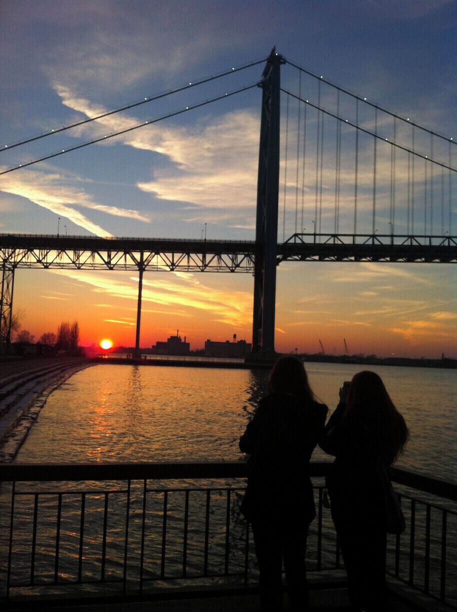 Going on an evening stroll along Riverside Dr. overlooking the Ambassador Bridge that connects with Detroit. 
